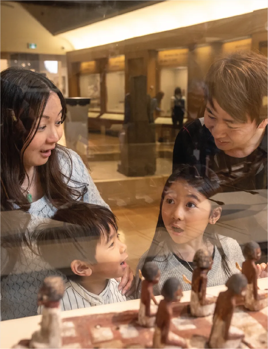 Family exploring ROM display together.